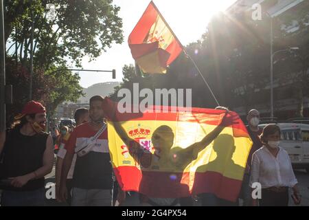 Barcelona, Spain. 22nd June, 2021. A protester is seen holding a Spanish flag during the protest.The Spanish far-right party, Vox, together with the political party, Ciudadanos, have called a demonstration in Barcelona's Artos Square, a regular place for far-right rallies, against the President of the Spanish Government, Pedro Sanchez, for the decision to pardon the prisoners Catalan independence politicians. Credit: SOPA Images Limited/Alamy Live News Stock Photo