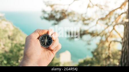 Male traveler with a compass in his hand. Stock Photo