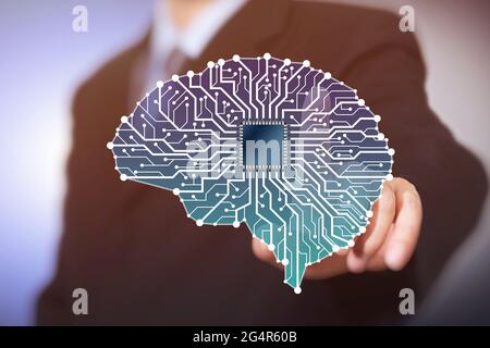 Businessman with Artificial Intelligence brain connects to technology network concept. Stock Photo