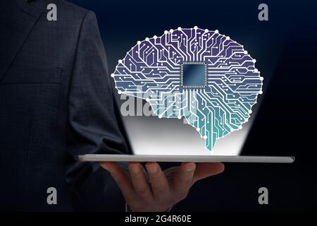 Businessman with Artificial Intelligence brain connects to technology network concept. Stock Photo