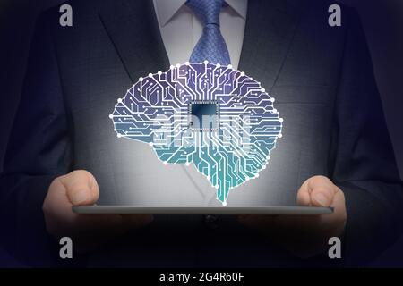 Businessman with Artificial Intelligence brain connects to technology network concept. Stock Photo