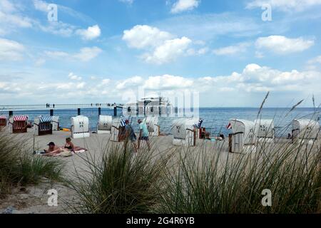 Timmendorf beach on German Baltic Sea with tourists in beach chairs and seabridge with japanese teahouse in backgrond, Travemunde, Germany, June 10., Stock Photo