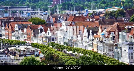 Aerial view of Travemunde with the historic brick houses of the old town and the trees of the avenue at the pedestrian zone, Travemunde, Germany, June Stock Photo