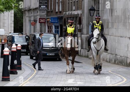 Two Women Officers with the City of London Police, ride their horses on a routine daily patrol through the City of London, the capital's financial district, on 22nd June 2021, in London, England. Stock Photo