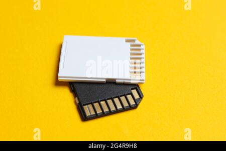 Two Mini SD memory cards on yellow background close up Stock Photo