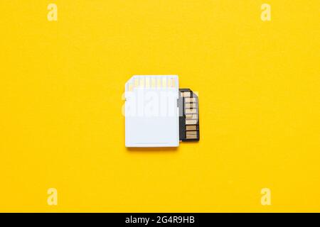 Two Mini SD memory cards on yellow background. Top view Stock Photo