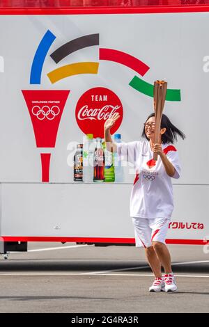 A local torchbearer runs during the Tokyo 2020 Olympic torch relay in Shiogama City, Miyagi Prefecture, Japan on June 20, 2021. Credit: Kosuke Ando/AFLO/Alamy Live News Stock Photo