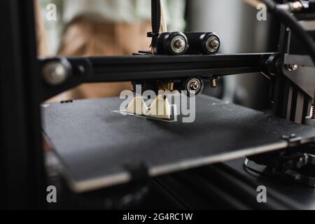 close up view of 3D printer creating plastic figure in modern office Stock Photo