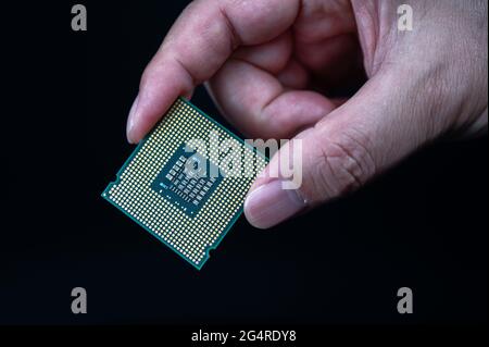 hand holding CPU on black background Stock Photo