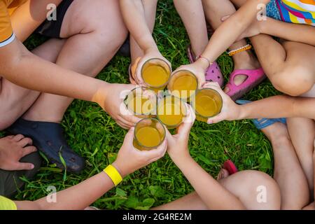 Children are drinking lemonade on the street together. Selective focus. Kids. Stock Photo