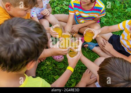 Children are drinking lemonade on the street together. Selective focus. Kids. Stock Photo