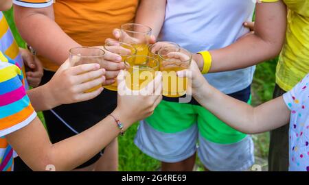 Children are drinking lemonade on the street together. Selective focus. Kids. Stock Photo