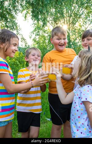 Children are drinking lemonade on the street together. Selective focus. Kids. Stock Photo