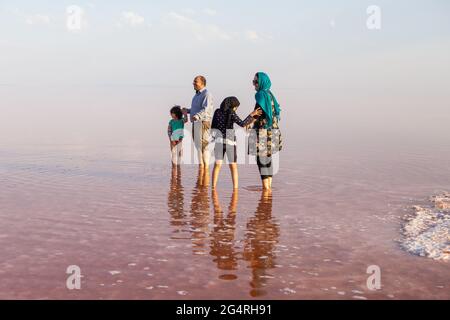 Iranian Family gets in salty waters on the beach of Urmia Lake in northwestern Iran.17 Sep 2016 Stock Photo