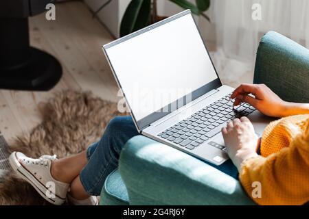Young woman using laptop screen blank, mock up, work home Stock Photo