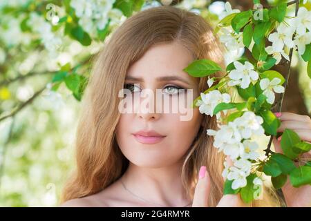 portrait of a woman with flowers in the garden Stock Photo