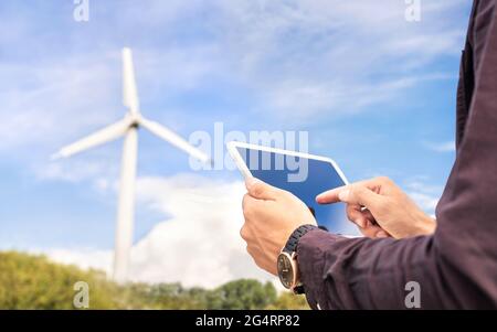 Wind power and sustainable energy field worker with tablet. Engineer or technician in green renewable electricity generation industry. Stock Photo
