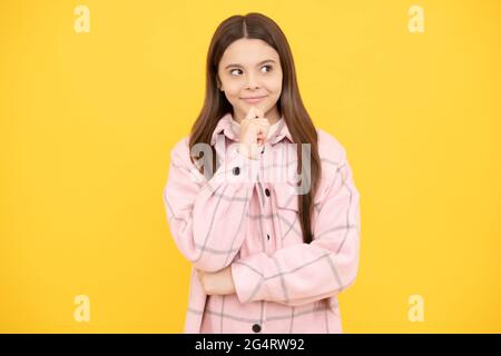 thoughtful kid girl wear pink checkered shirt, decision Stock Photo