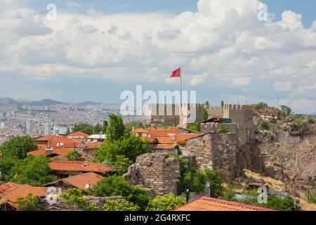 Panoramic of Ankara castle and Turkish flag in Post under cloudy blue sky Stock Photo