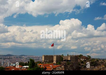 Panoramic of Ankara castle and Turkish flag in Post under cloudy blue sky Stock Photo