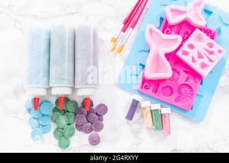 Flat lay. Ingredients to make chocolate mermaid molds from the chocolate chips. Stock Photo