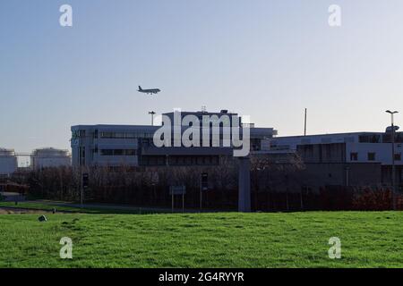 DUBLIN, IRELAND - Jan 15, 2020: Exterior of the Aer Lingus building with landing Aer Lingus aircraft above in the background. Dublin airport. Green la Stock Photo