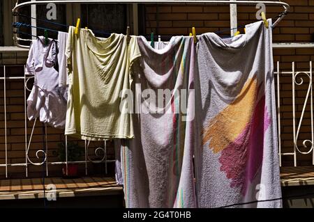 Clothes hung out to dry on lines outside the balcony (Marche, Italy, Europe) Stock Photo