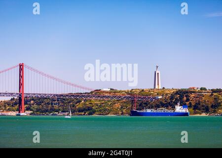 The 25 April bridge (Ponte 25 de Abril) is a steel suspension bridge located in Lisbon, Portugal, crossing the Targus river. Cristo Rei or Christ the Stock Photo