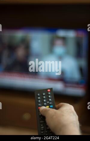 Someone who constantly changes channels while watching TV. selective focus remote control Stock Photo