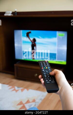 Someone who constantly changes channels while watching TV. selective focus remote control Stock Photo