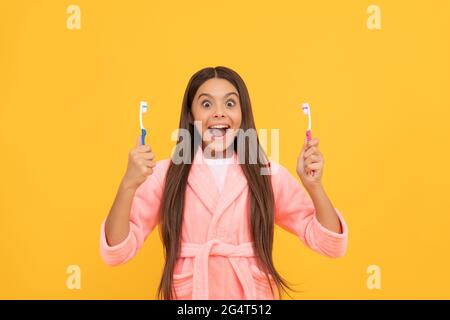 morning routine. kid wear soft night suit. child in cozy sleepwear brush teeth. Stock Photo