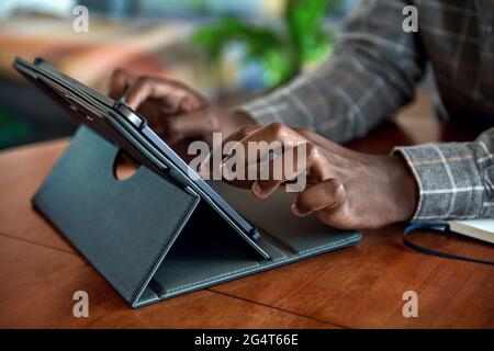 African businessman working from home using a digital tablet Stock Photo