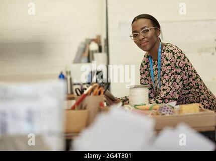 Young African female fashion designer using a tablet in her studio Stock Photo