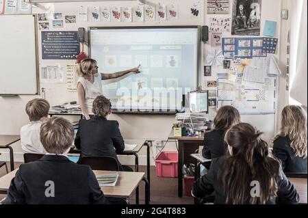 Female French teacher with a class of teenagers. England. UK Stock Photo