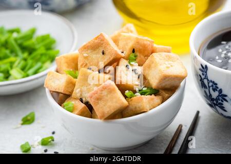 Fried tofu with sesame seeds in a bowl. Asian food Stock Photo