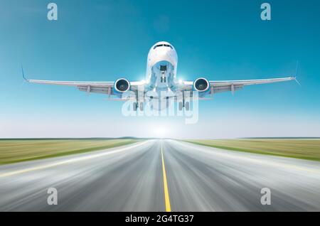 Airplane split-scimitar wing flying departure landing speed motion on a runway in the clear sky bright day Stock Photo