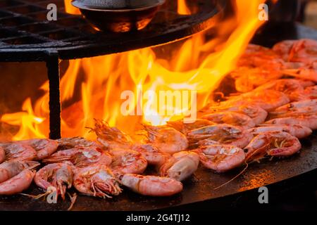 Process of grilling red king prawns on brazier with hot flame Stock Photo