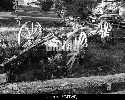 An old broken wooden Wagon in black and white, in the late afternoon sunlight in Escalante, Utah USA Stock Photo