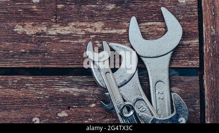 Close-up image of a set of wrenches on a wooden table Stock Photo