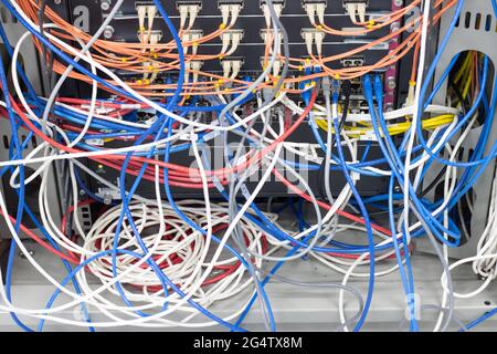 cable network in server room cable tangled of poorly routed cables Concept Organized Cabling in server rooms Stock Photo