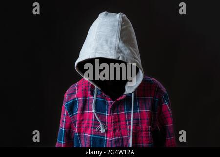 faceless incognito man wear hood on dark background isolated Stock Photo