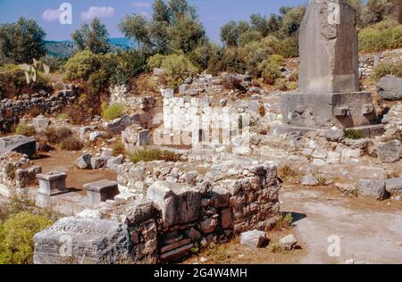 Xanthos - ruins of ancient town In Antalya province (the largest city in Lycia in Hellenistic era), Turkey. Lycian Tombs of Xanthos - with Xanthian Obelisk. Archival scan from a slide. October 1985. Stock Photo