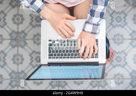 buisnessman sit on toilet and work with laptop in bathroom Stock Photo