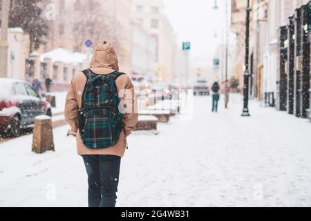 person walk in city streets in winter season under snowfall Stock Photo
