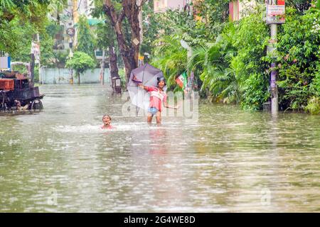 Some moments of naughtiness of two boys on the streets of Kolkata submerged in the rain. Looking at this picture reminds us of our childhood memories. Stock Photo