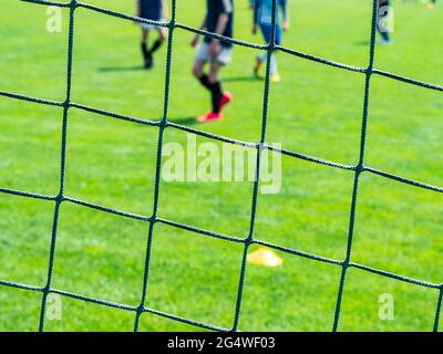 Net of a soccer goal , two teams playing the soccer Stock Photo