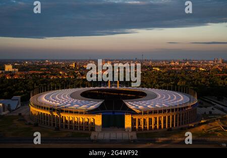 Berlin, Germany. 23rd June, 2021. Football: European Championship, preliminary round, Group E, Germany - Hungary. The setting sun shines on the Olympic Stadium in Berlin. Credit: Christophe Gateau/dpa/Alamy Live News Stock Photo