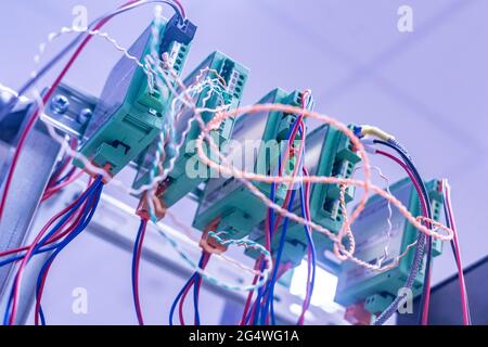 bunch of wires inserted in elctric controller Stock Photo