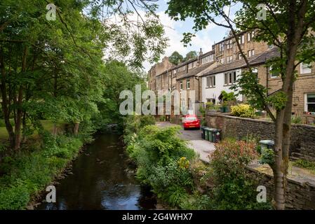 Hinchliffe Mill near Holmfirth, West Yorkshire. Old stone cottages beside the river Holme. An area used to film comedy 'Last of the Summer Wine' Stock Photo