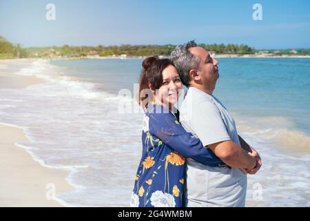 Middle-aged couple embracing on a beach. Stock Photo